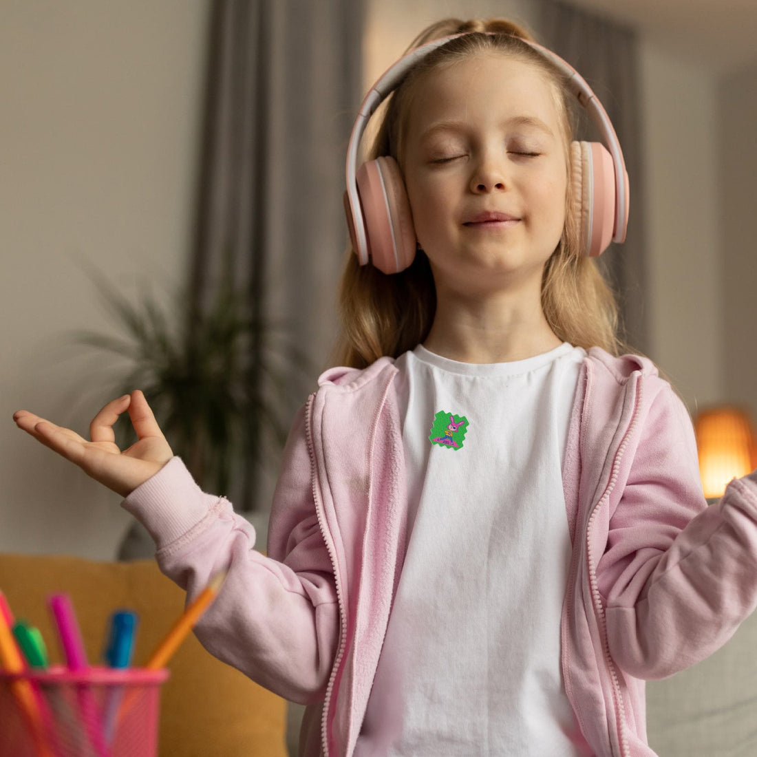 A child looking calm and focused while wearing a mood-calming sticker on their shirt. 