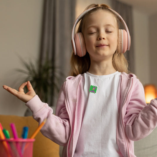 A child looking calm and focused while wearing a mood-calming sticker on their shirt. 