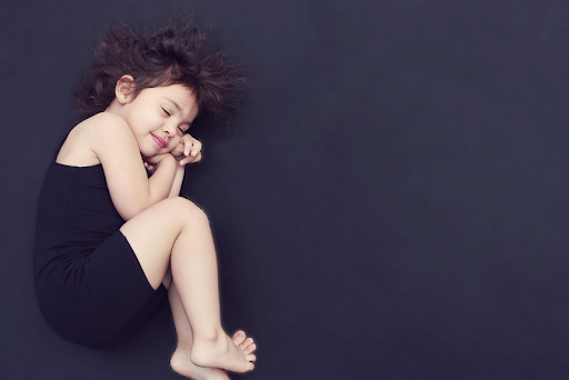 A child sleeping peacefully, showing the calming effects of sleep stickers. 