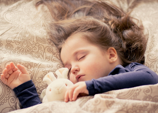 A child sleeping peacefully on their side with clear, unobstructed breathing. 