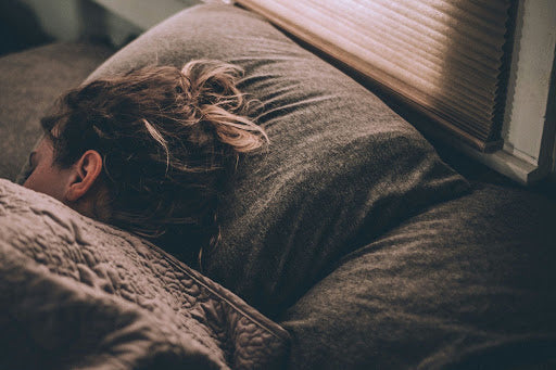 Woman sleeping soundly on a bed 