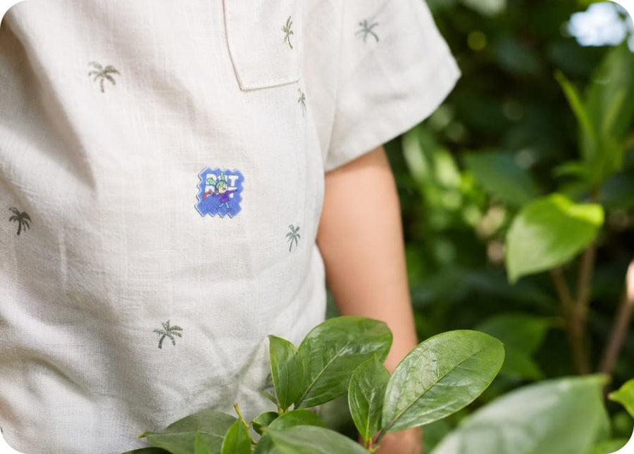 A child outdoors wearing BuzzPatch stickers on their clothing, ready to play.