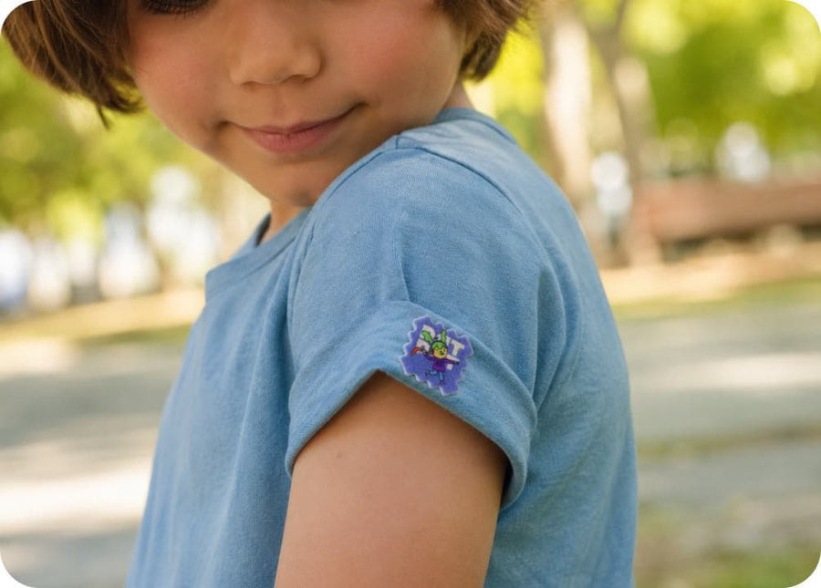 A child outdoors wearing BuzzPatch stickers on their clothing, ready to play.