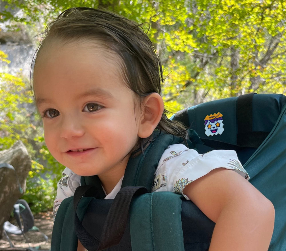 Child outdoors wearing a BuzzPatch sticker