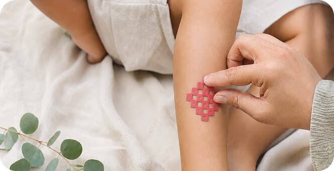 Parent applying plant-based itch relief patch