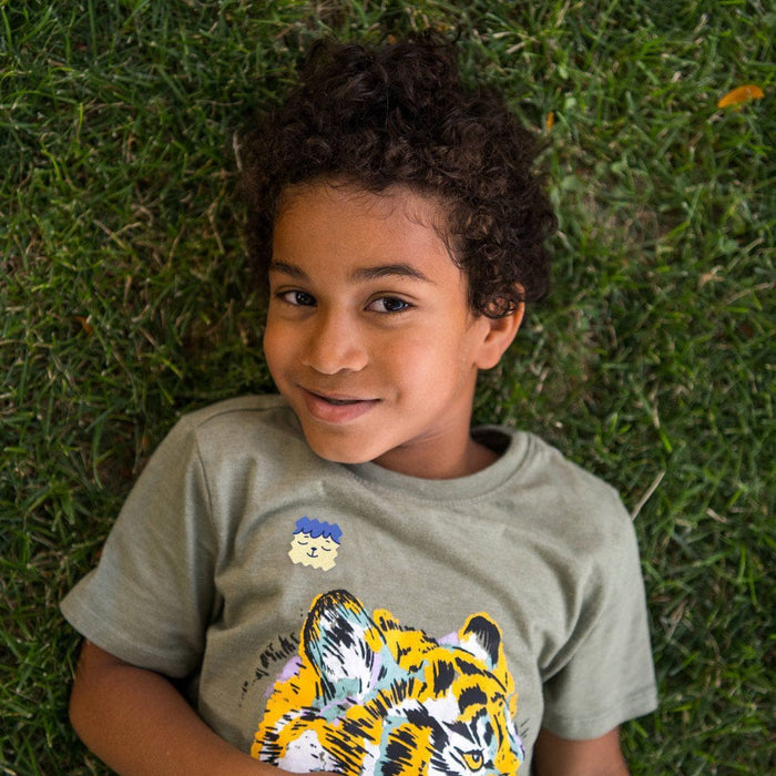 Child outdoors wearing a ZenPatch sticker