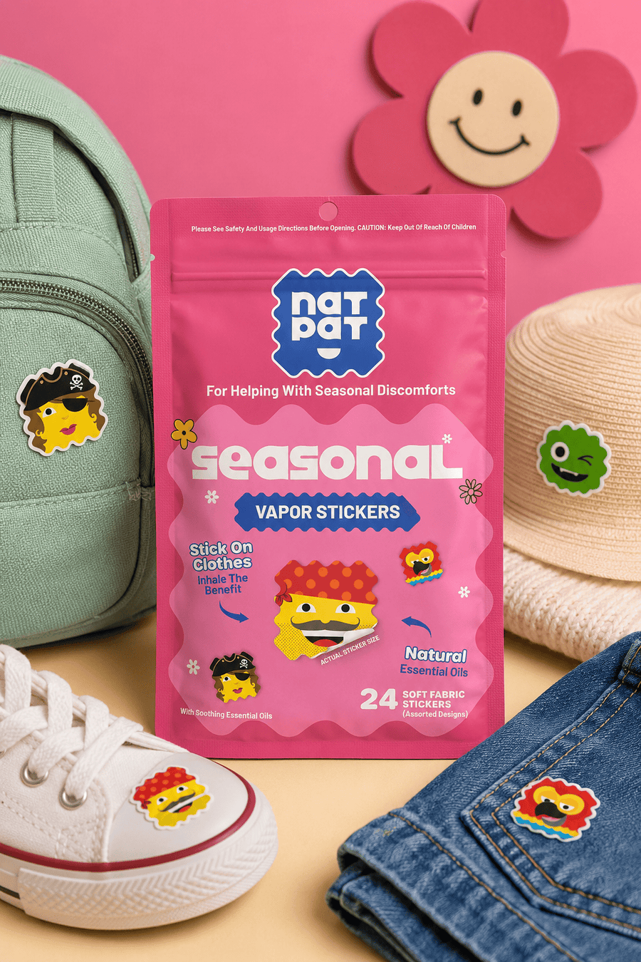 The Seasonal vapor stickers pouch surrounded by a backpack, hat, sneaker and jeans, each with a sticker patch applied.