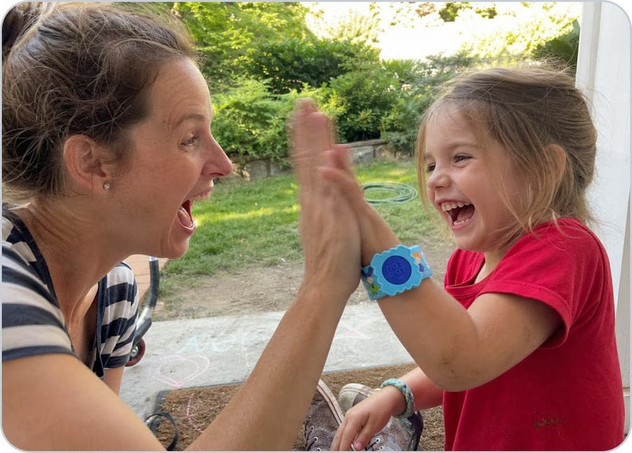 A parent loads the citronella pellet into the Slap Band before a child heads outside.