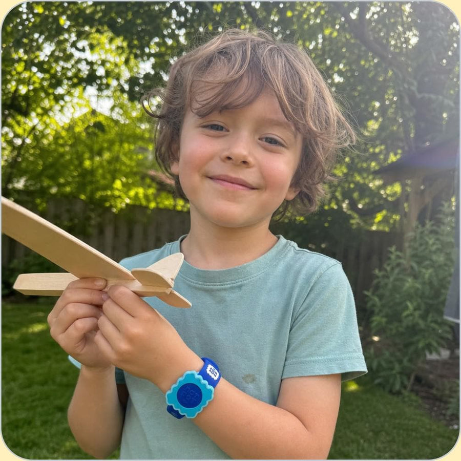A child wearing the NATPAT mosquito repellent Slap Band outdoors.