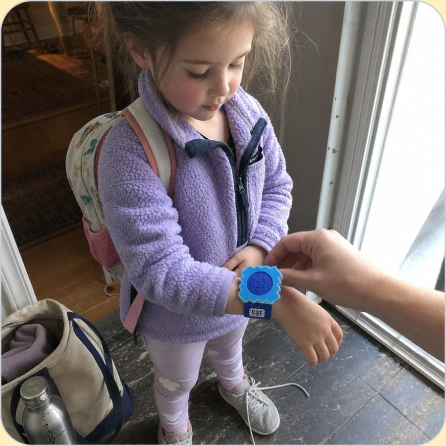 A child wearing the NATPAT mosquito repellent Slap Band outdoors.