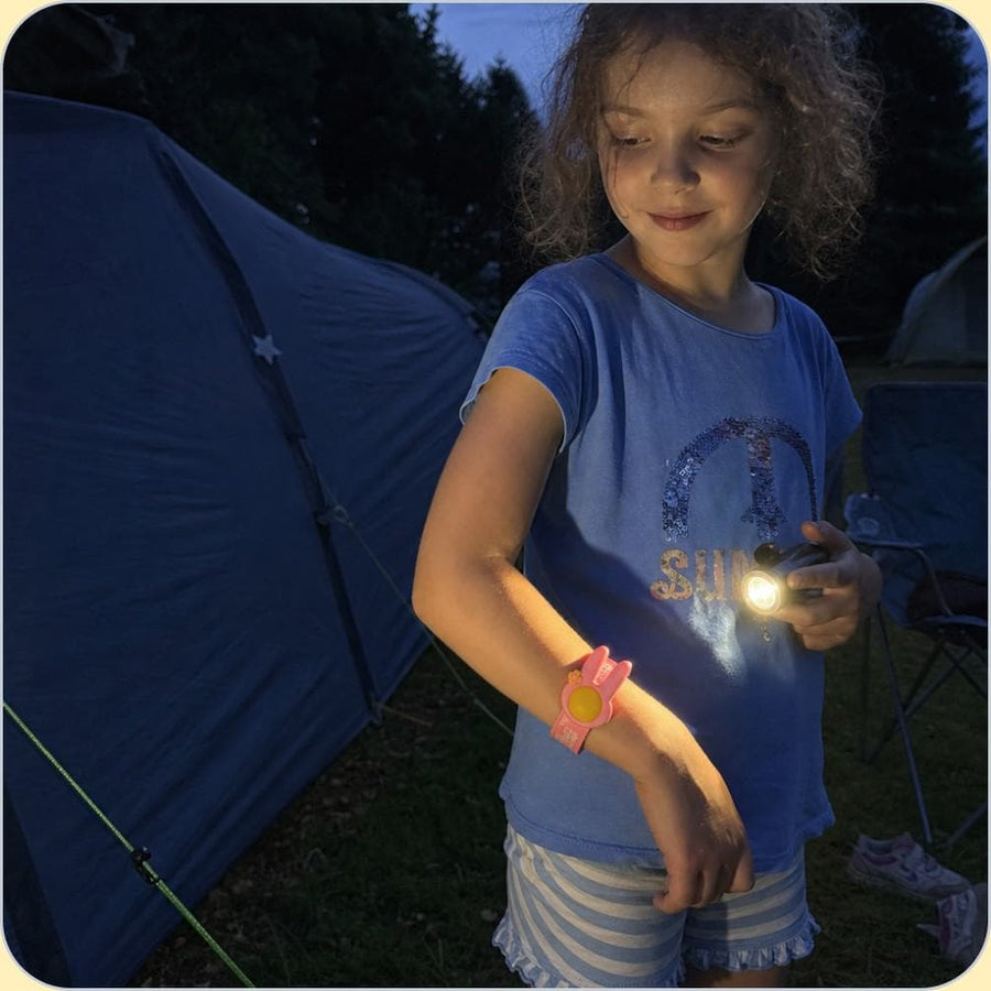 A child wearing the NATPAT mosquito repellent Slap Band outdoors.