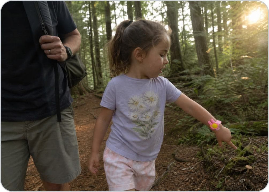 A parent loads the citronella pellet into the Slap Band before a child heads outside.