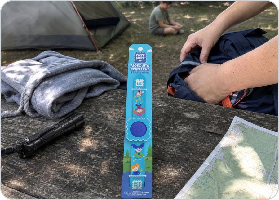 A parent loads the citronella pellet into the Slap Band before a child heads outside.