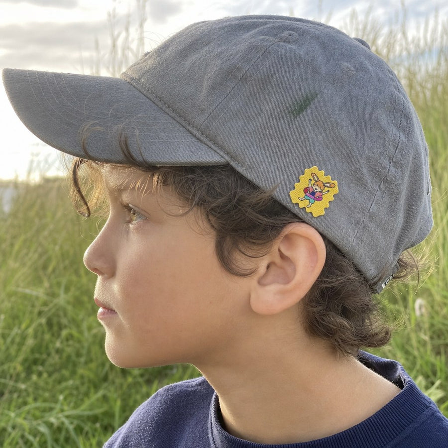 Parent and child on a forest trail, a TrailPatch sticker on the child's shirt.